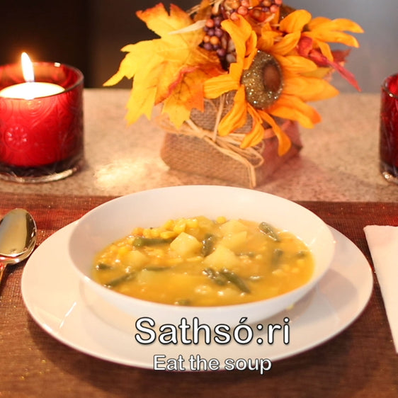 Photo of a bowl of soup and a candle and flower